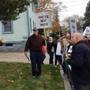 Protesters speak to the film?s codirector, Jeremy Earp (left), in front of the Universalist Unitarian Church Sunday before the screening. (Bette Keva photo)